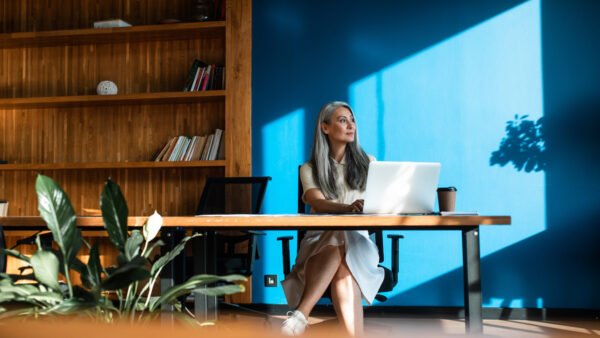 cinematic image of a senior  business woman. Portrait of an employee in her office